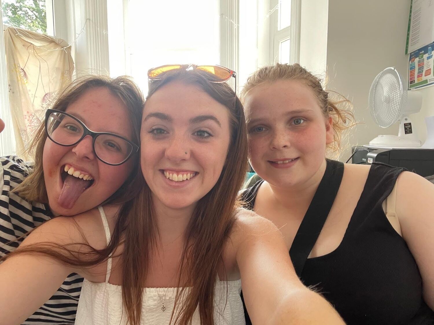 Three friends grinning together for a selfie