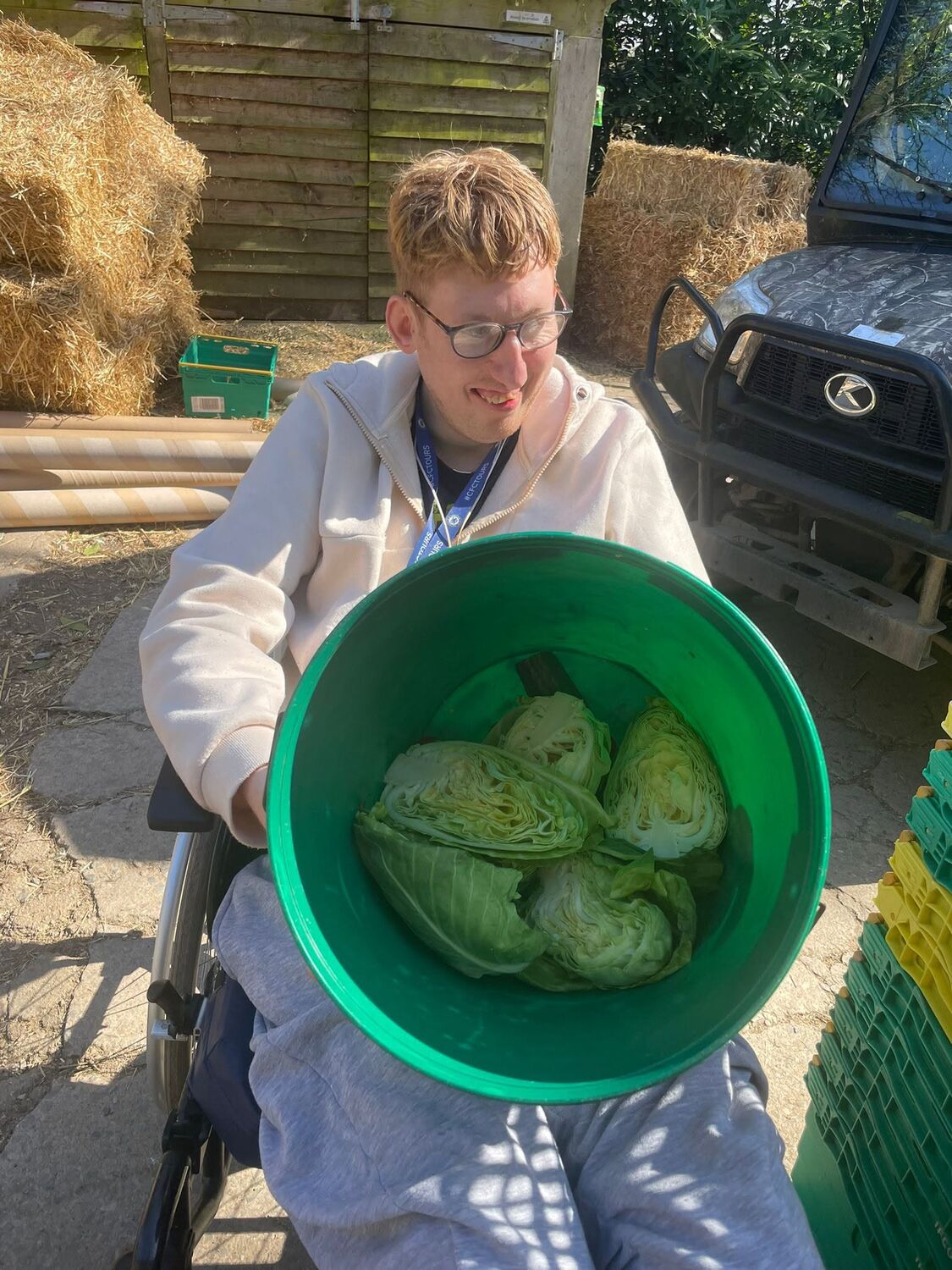 Proudly holding a tub of home-grown lettuces